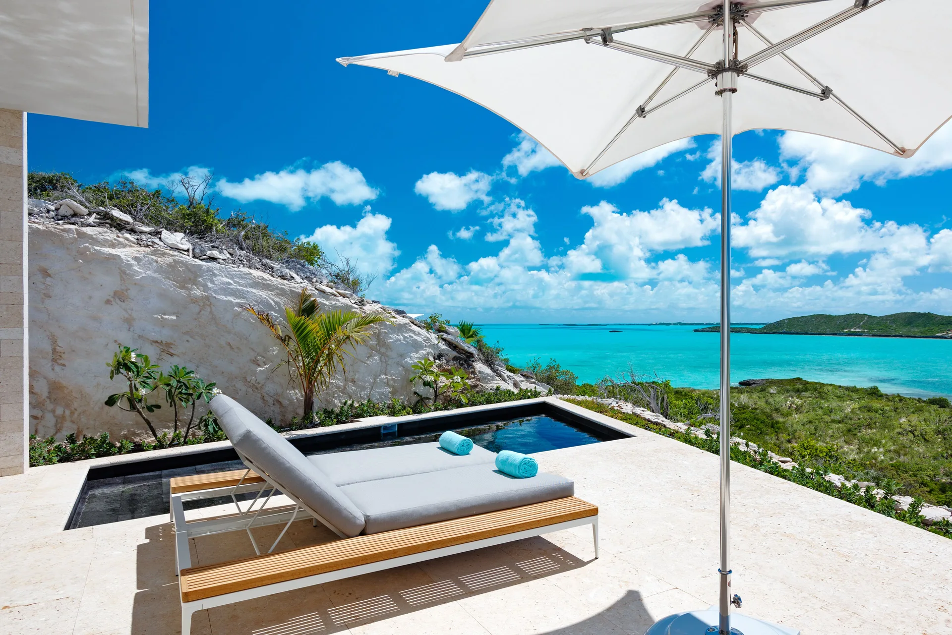 Private plunge pool terrace with lounger and sea view at Wymara Resort and Villas.