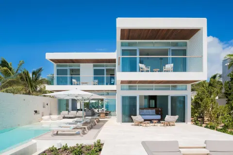 Modern white villa exterior with pool and balconies at Wymara Resort and Villas.
