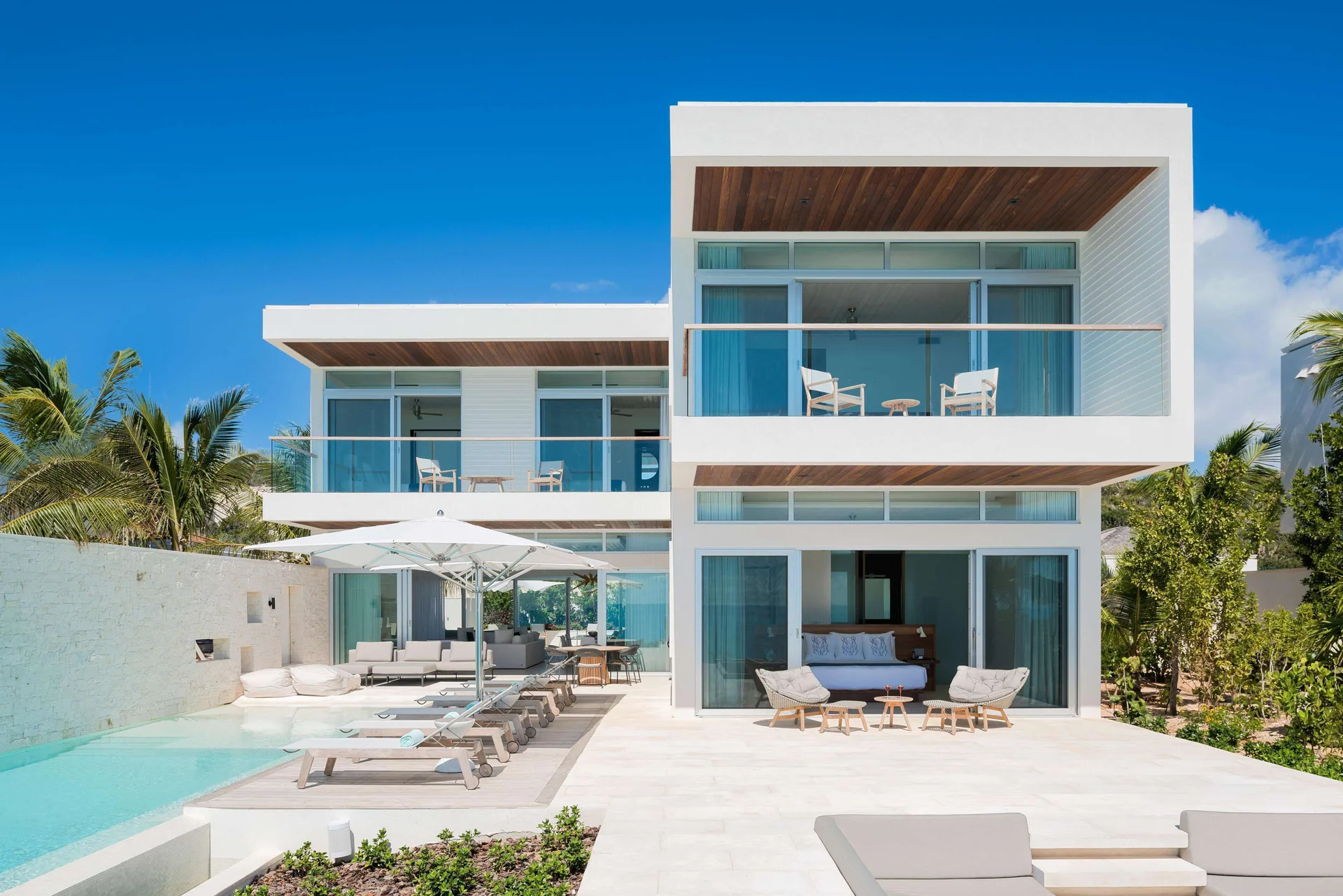 Modern white villa exterior with pool and balconies at Wymara Resort and Villas.