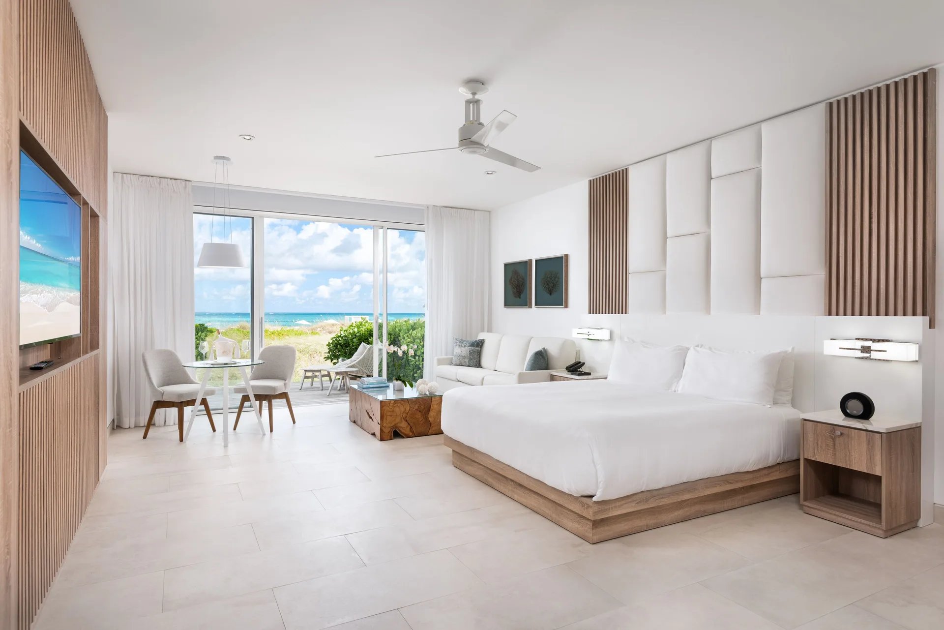 Deluxe Studio Oceanfront king bed with ocean-facing terrace at Wymara Resort and Villas.