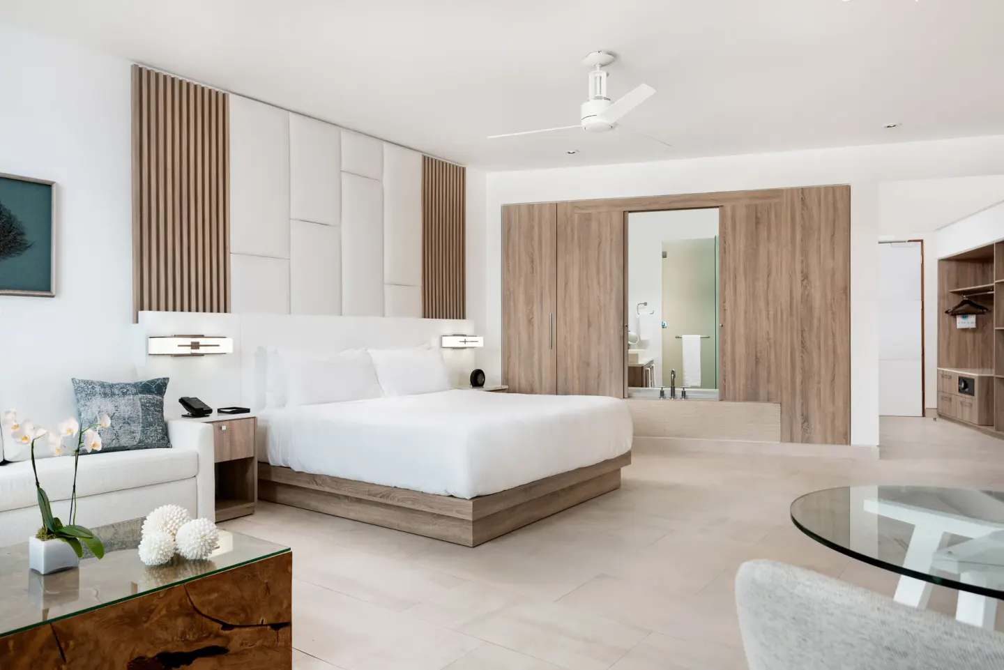 Deluxe Studio Oceanfront king bed and seating area at Wymara Resort and Villas.