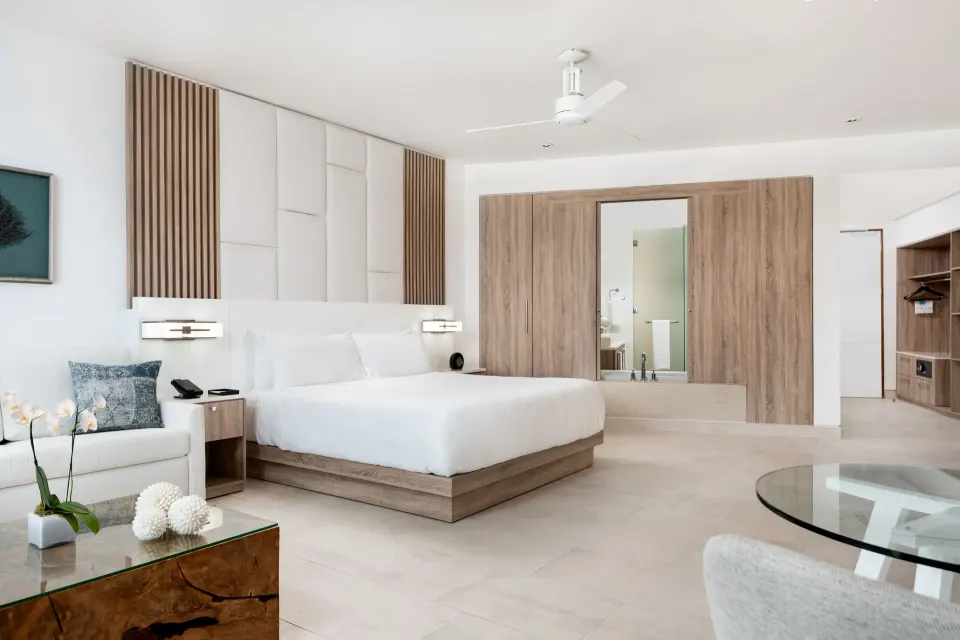 Deluxe Studio Oceanfront king bed and seating area at Wymara Resort and Villas.