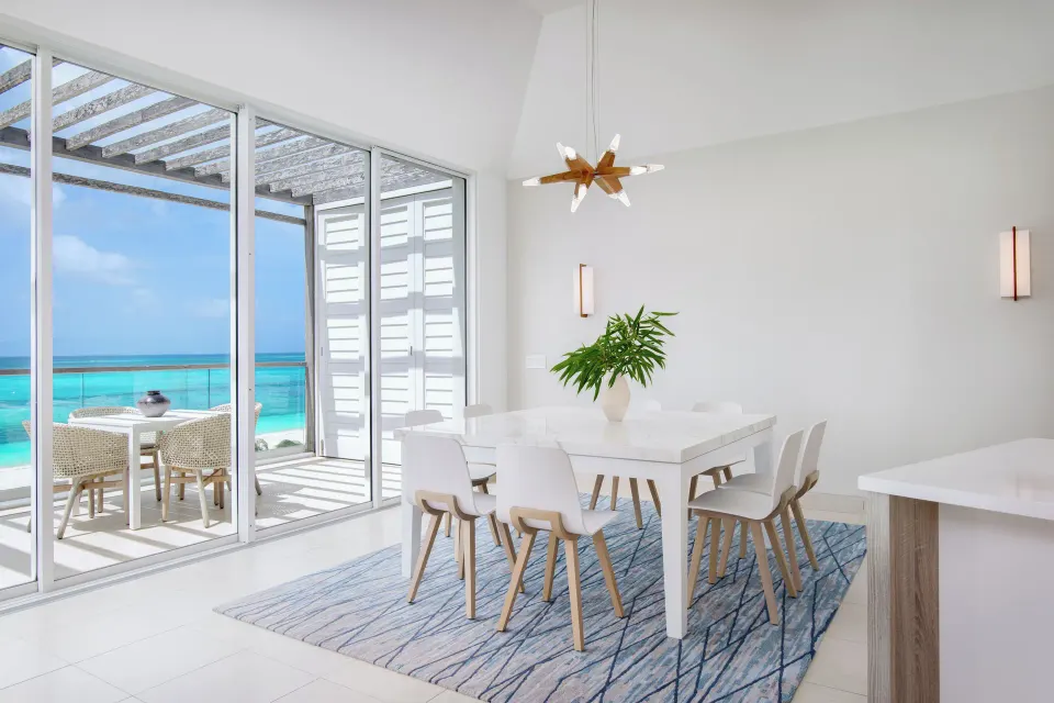 Penthouse one-bedroom suite dining area beside ocean-facing balcony at Wymara Resort and Villas.