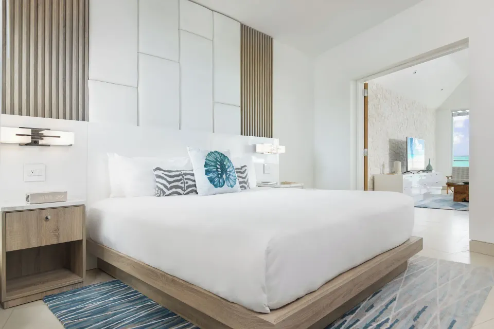 Penthouse one-bedroom suite king bed and doorway to lounge at Wymara Resort and Villas.
