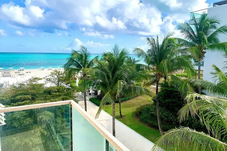 Studio Ocean View balcony view of palms, beach, and ocean at Wymara Resort and Villas.
