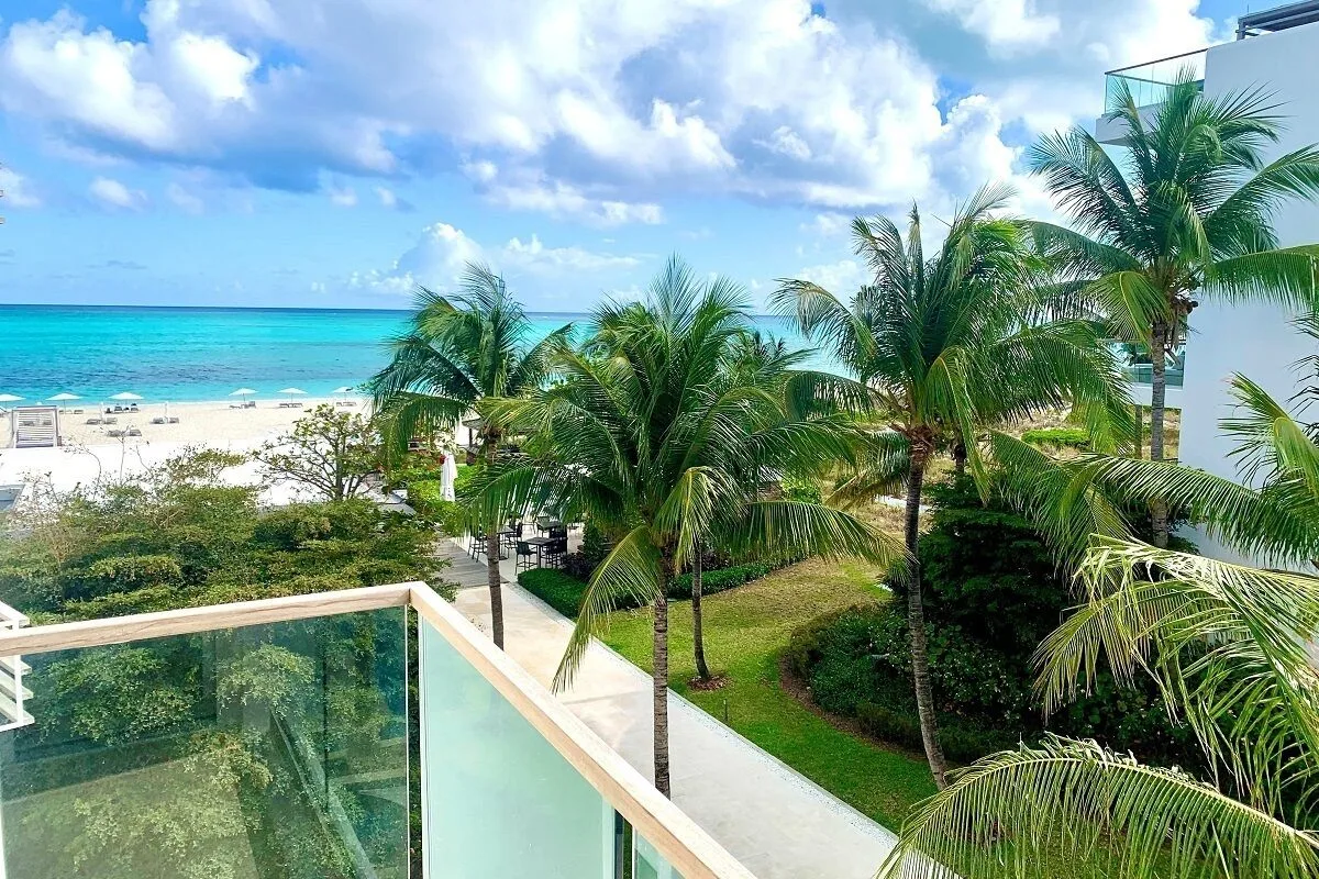 Studio Ocean View balcony view of palms, beach, and ocean at Wymara Resort and Villas.
