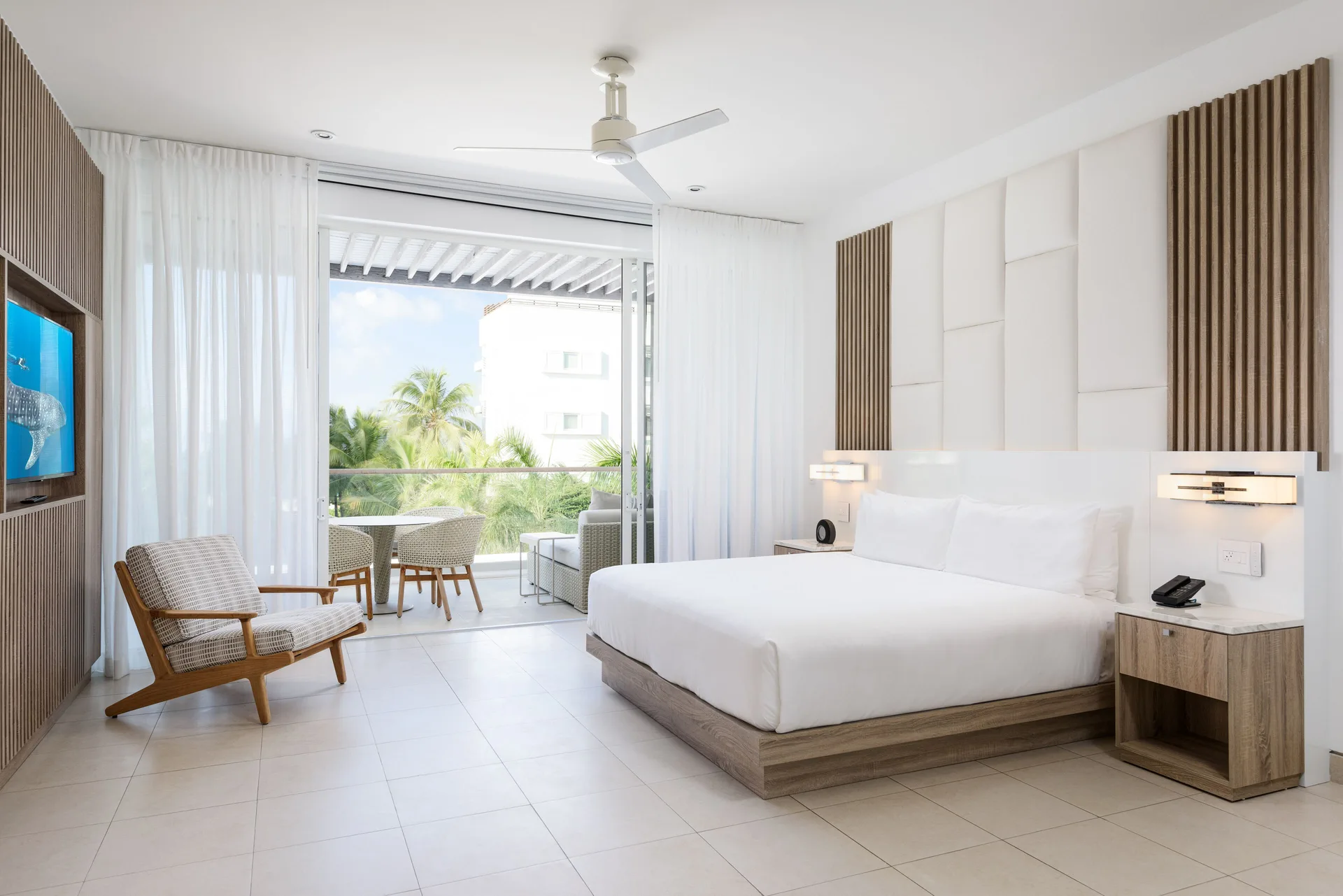 Studio Pool View room with king bed and balcony seating at Wymara Resort and Villas.