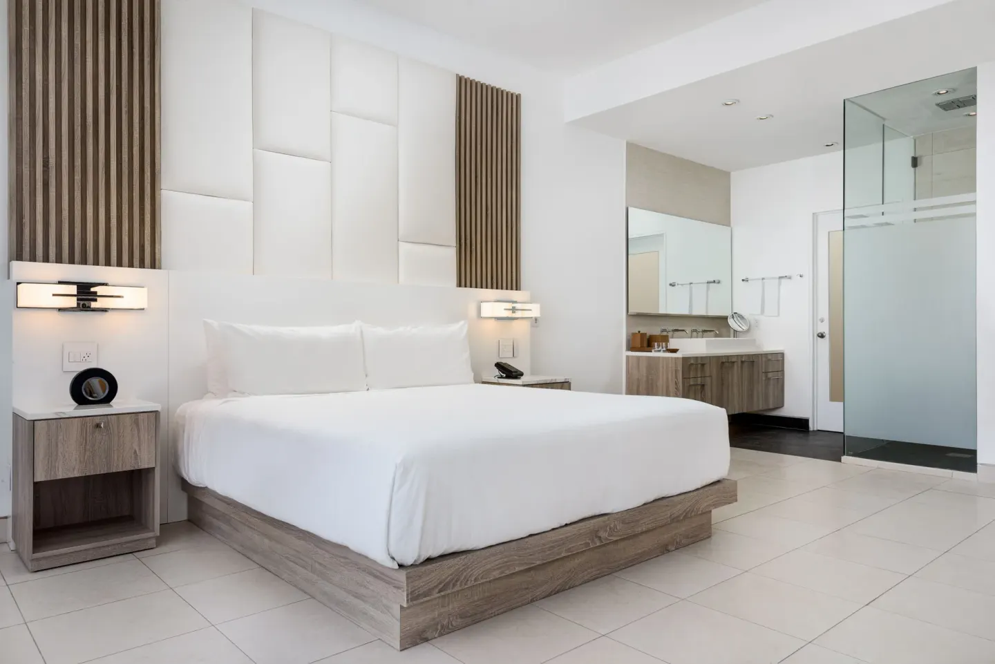Studio Pool View king bed beside open bathroom area at Wymara Resort and Villas.