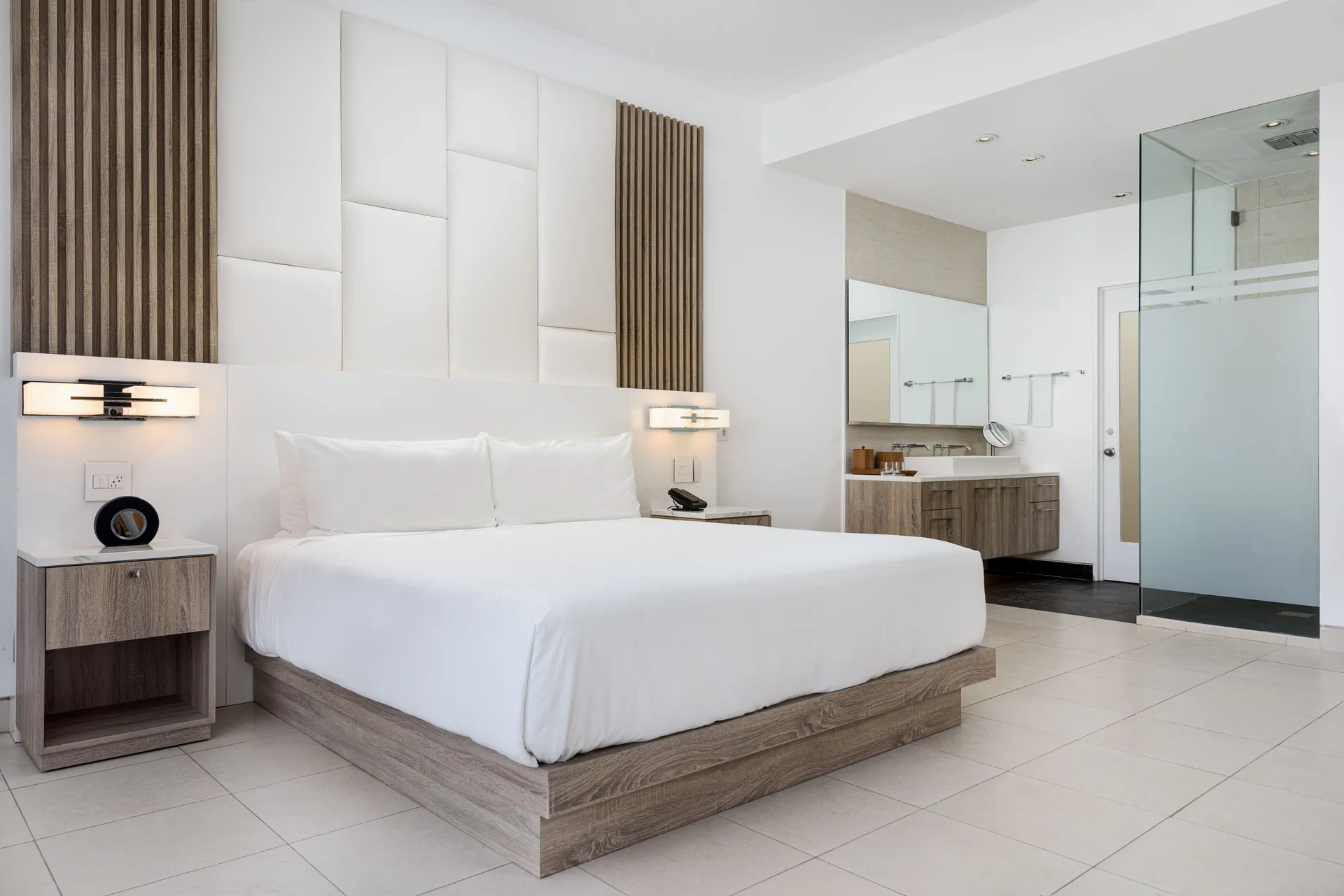 Studio Pool View king bed beside open bathroom area at Wymara Resort and Villas.