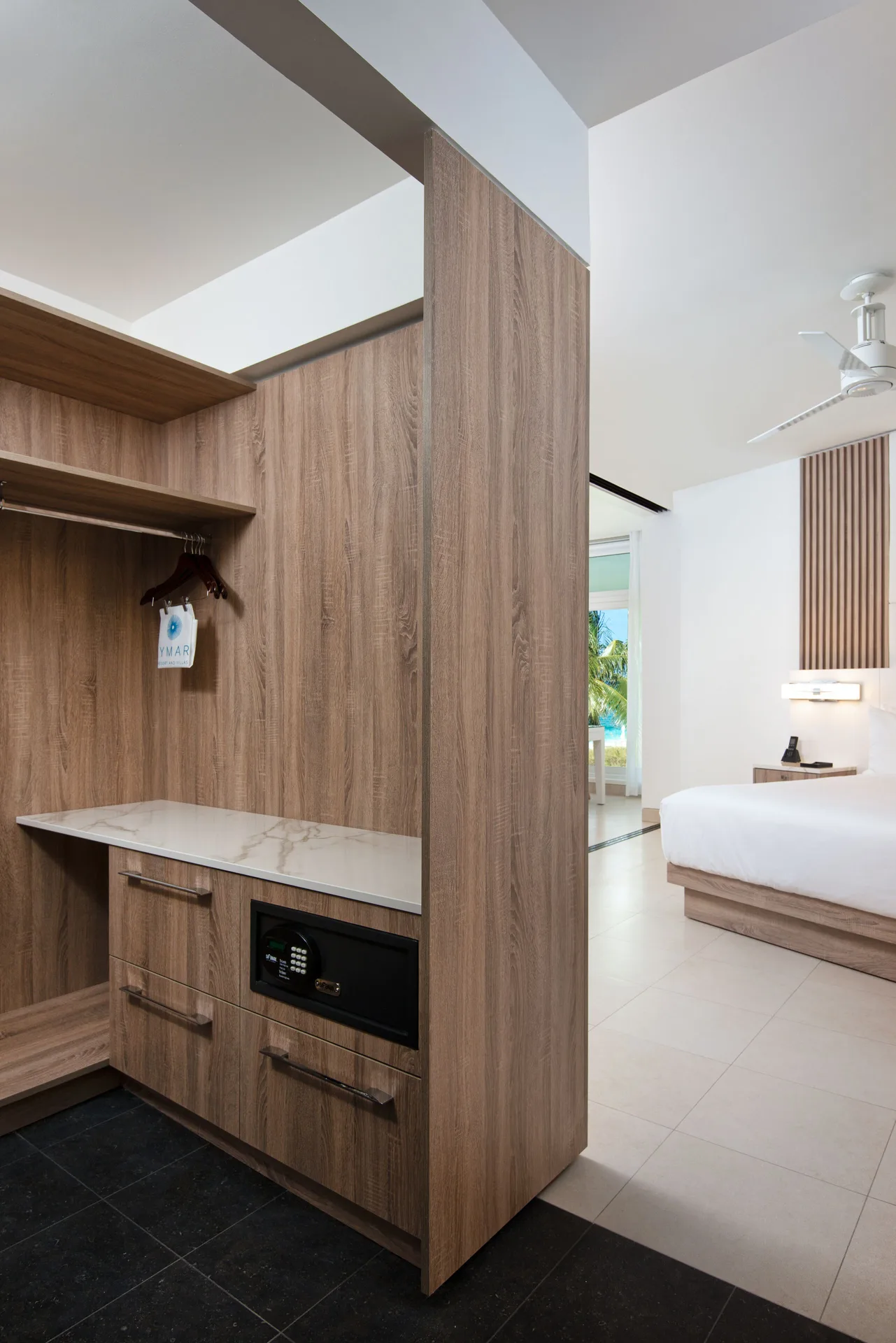 Oceanfront suite closet with safe beside king bedroom at Wymara Resort and Villas.