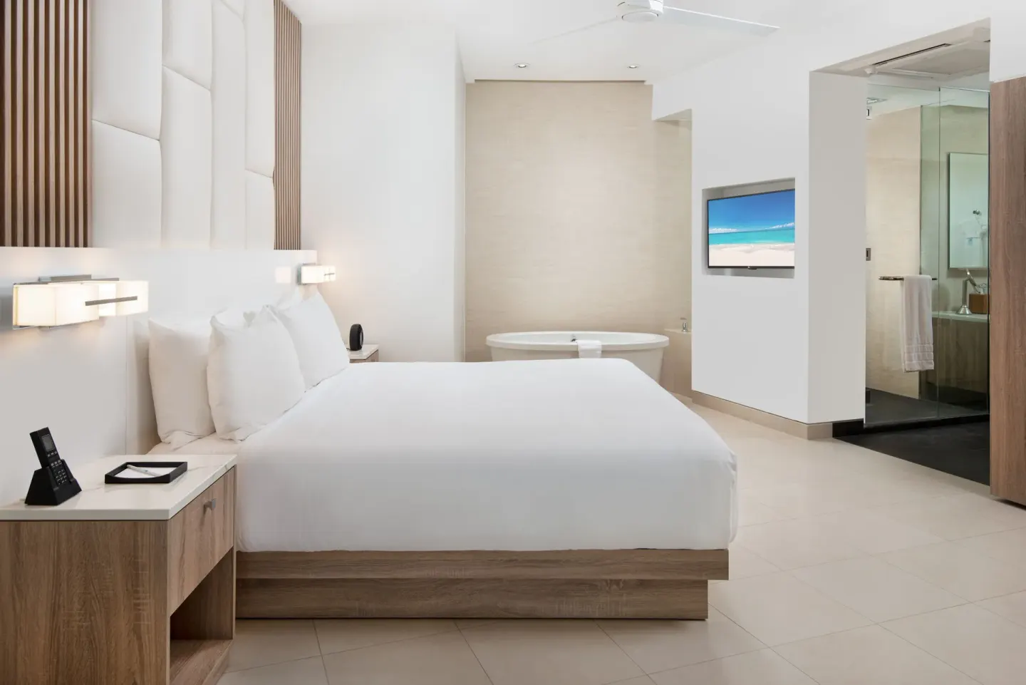 Oceanfront one-bedroom suite king bed and soaking tub at Wymara Resort and Villas.