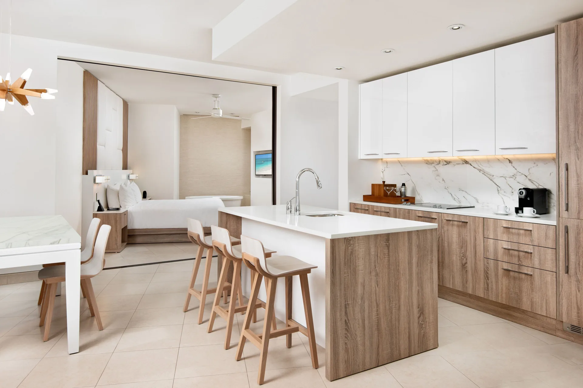 Oceanfront one-bedroom suite kitchen and bedroom at Wymara Resort and Villas.
