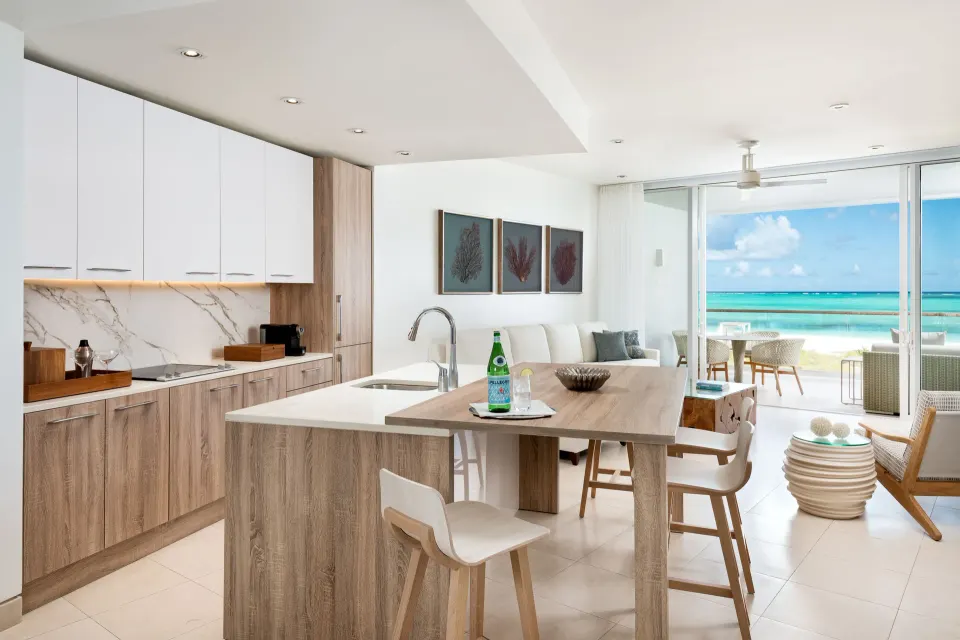 Oceanfront suite kitchen and lounge opening to the sea at Wymara Resort and Villas.