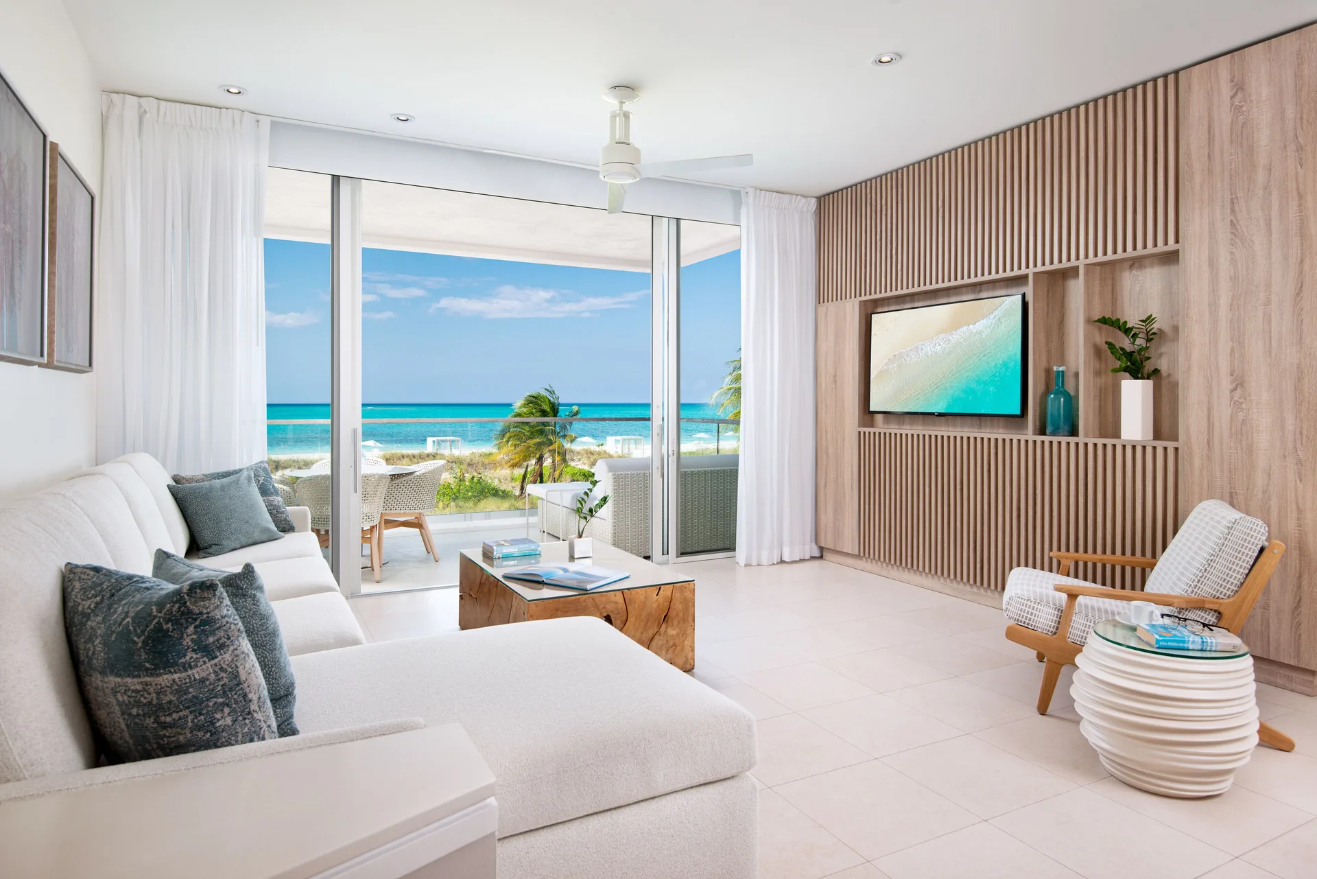 Oceanfront suite living room with balcony and sea view at Wymara Resort and Villas.