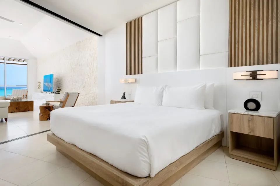 Oceanfront penthouse suite king bedroom beside the living room at Wymara Resort and Villas.