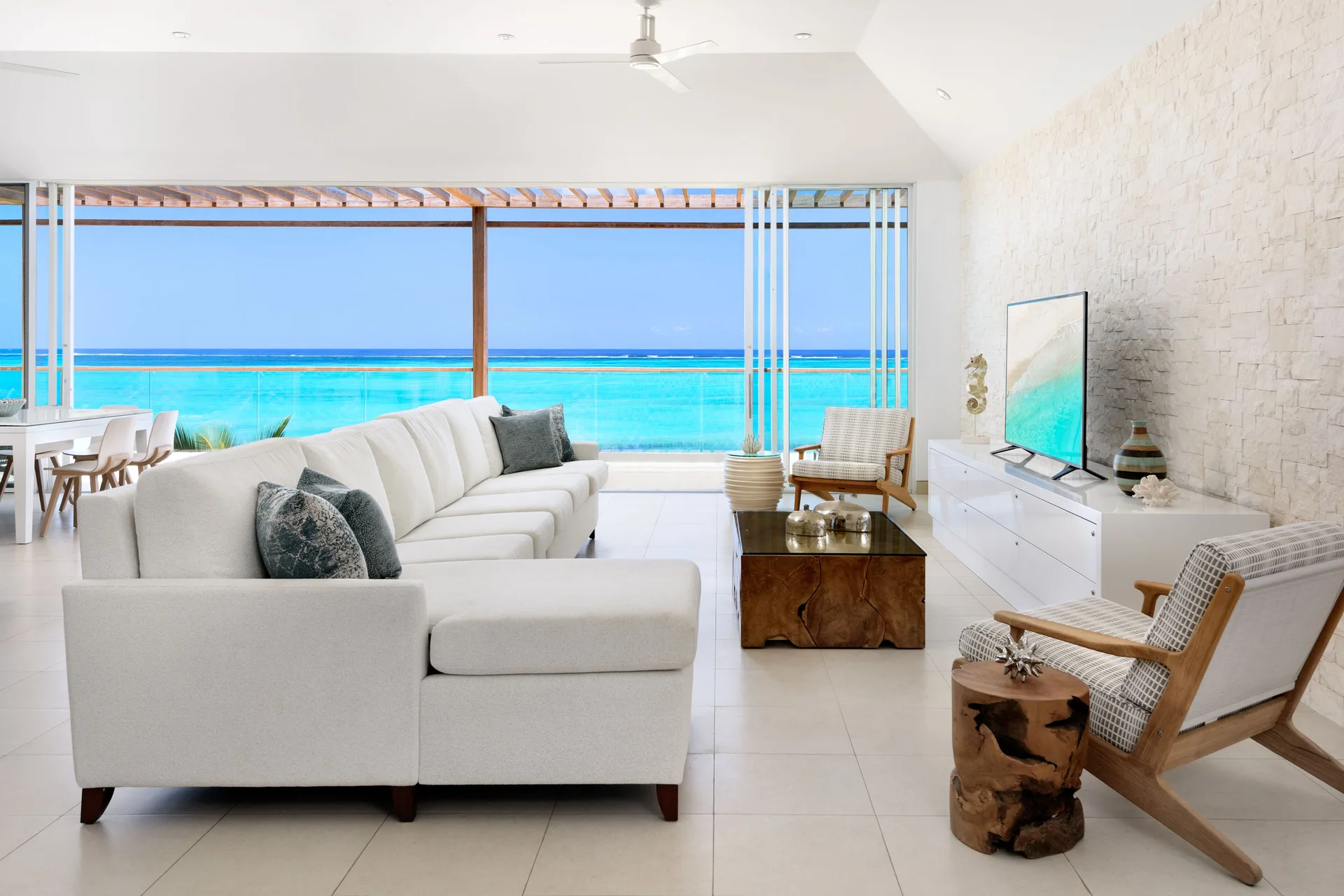 Oceanfront penthouse suite living room with ocean view at Wymara Resort and Villas.