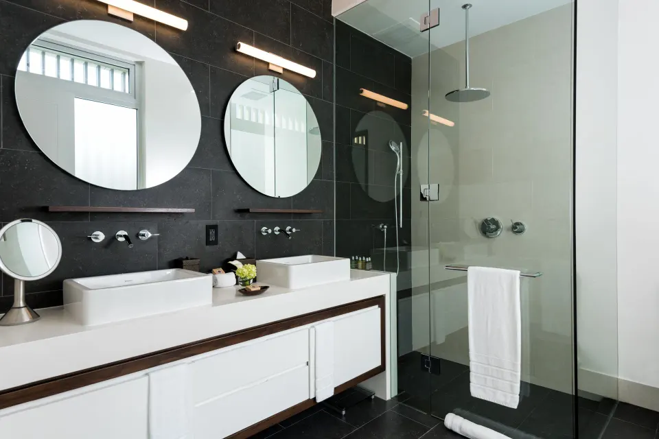 Villa bathroom with twin sinks and glass shower at Wymara Resort and Villas.
