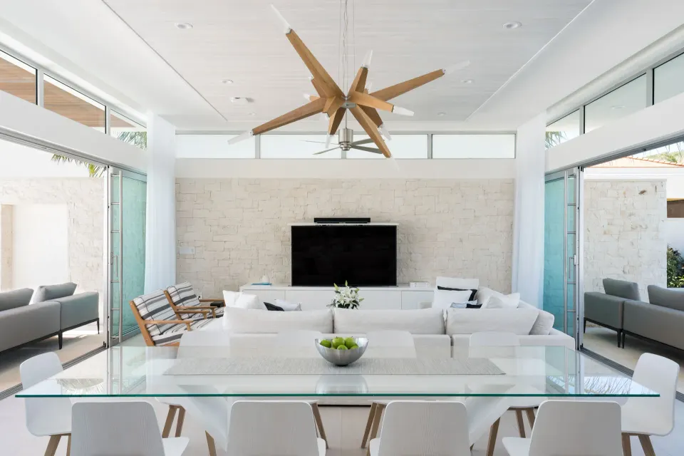 Open villa living and dining area with glass table at Wymara Resort and Villas.