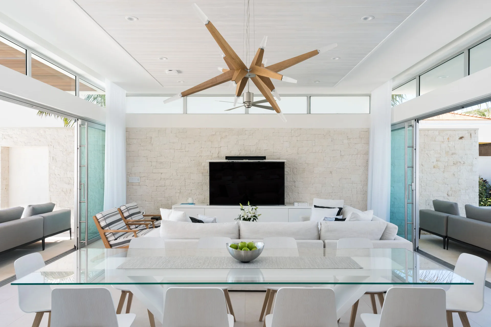 Open villa living and dining area with glass table at Wymara Resort and Villas.