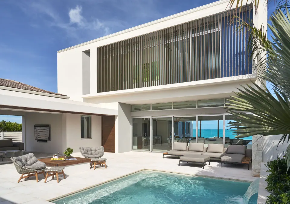 Private villa pool courtyard with ocean beyond at Wymara Resort and Villas.