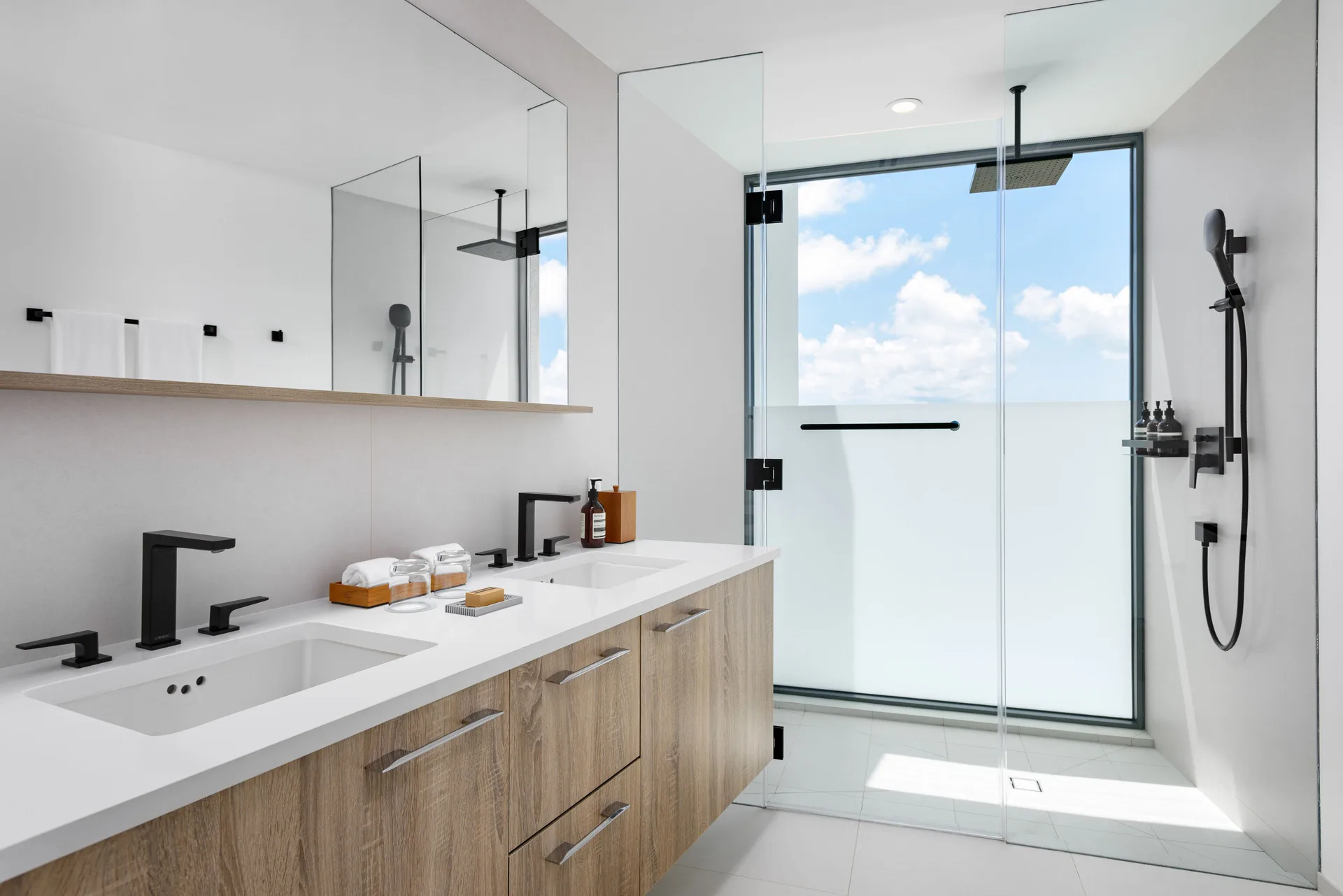 Villa bathroom with double vanity and glass shower at Wymara Resort and Villas.