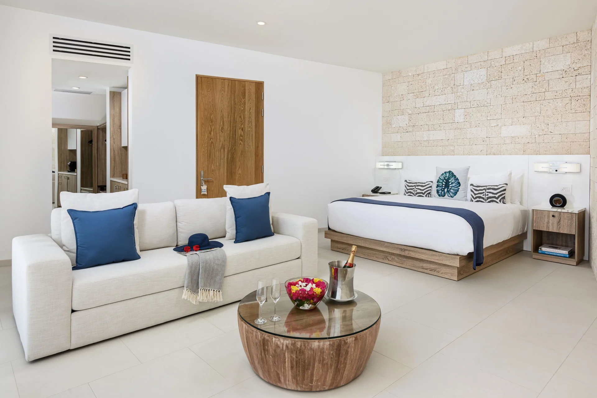 Five-bedroom villa guest room with king bed and sofa at Wymara Resort and Villas.