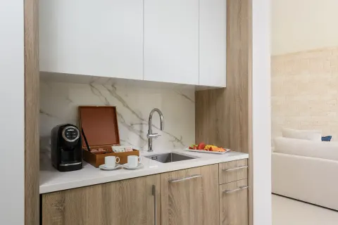 Villa kitchenette with coffee setup and sink at Wymara Resort and Villas.