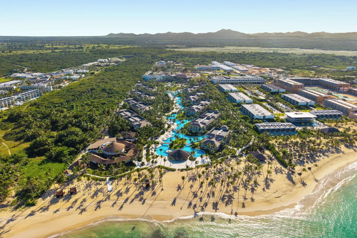 Aerial view of the beachfront resort and pools at Wyndham Alltra Punta Cana.