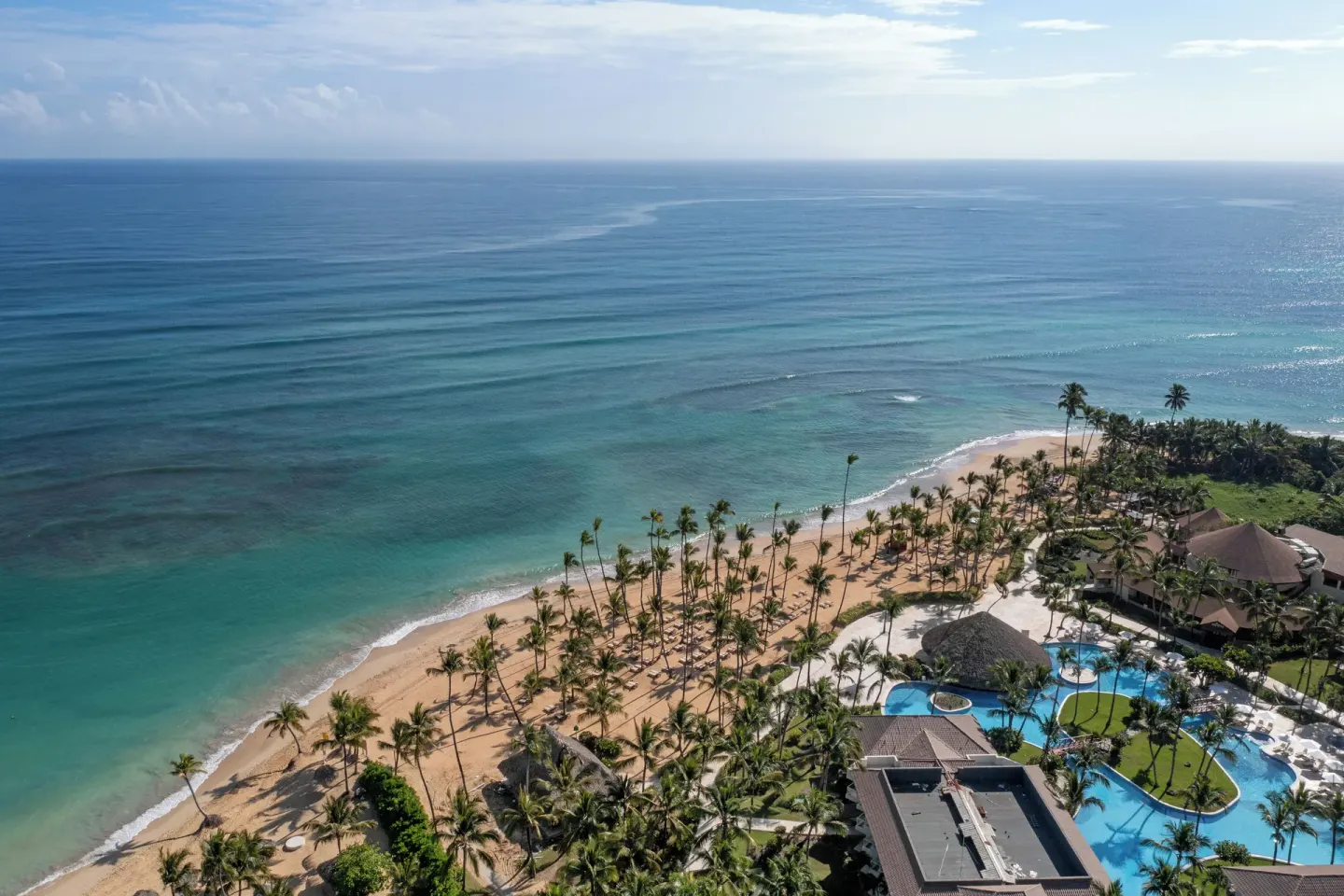Aerial oceanfront view of the beach and pools at Wyndham Alltra Punta Cana.