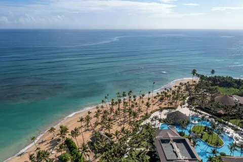 Aerial oceanfront view of the beach and pools at Wyndham Alltra Punta Cana.