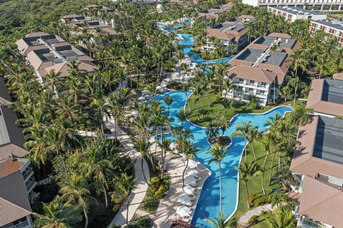 Aerial view of winding pools and palms at Wyndham Alltra Punta Cana.