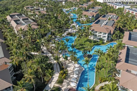 Aerial view of winding pools and palms at Wyndham Alltra Punta Cana.