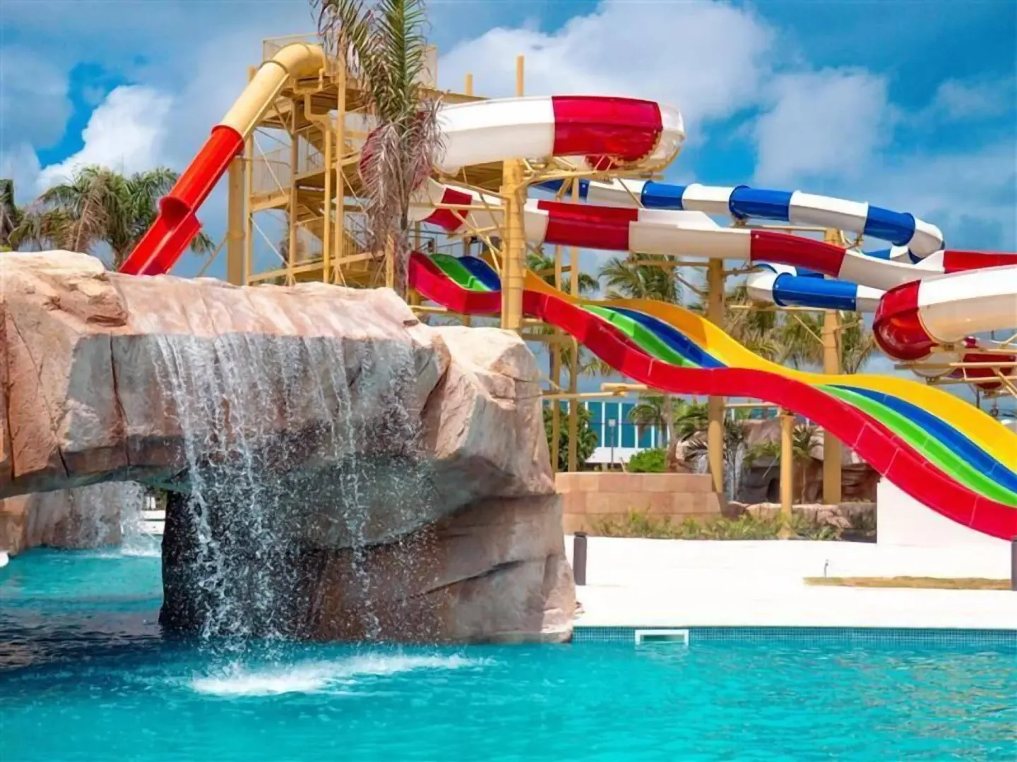 Colorful water slides and rock waterfall at Wyndham Alltra Punta Cana.