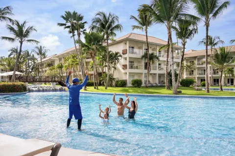 Pool activity with a family and staff member at Wyndham Alltra Punta Cana.