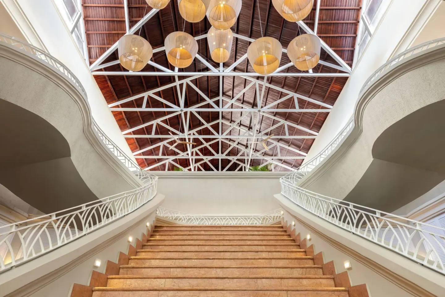 Grand staircase and vaulted wood ceiling in the lobby at Wyndham Alltra Punta Cana.