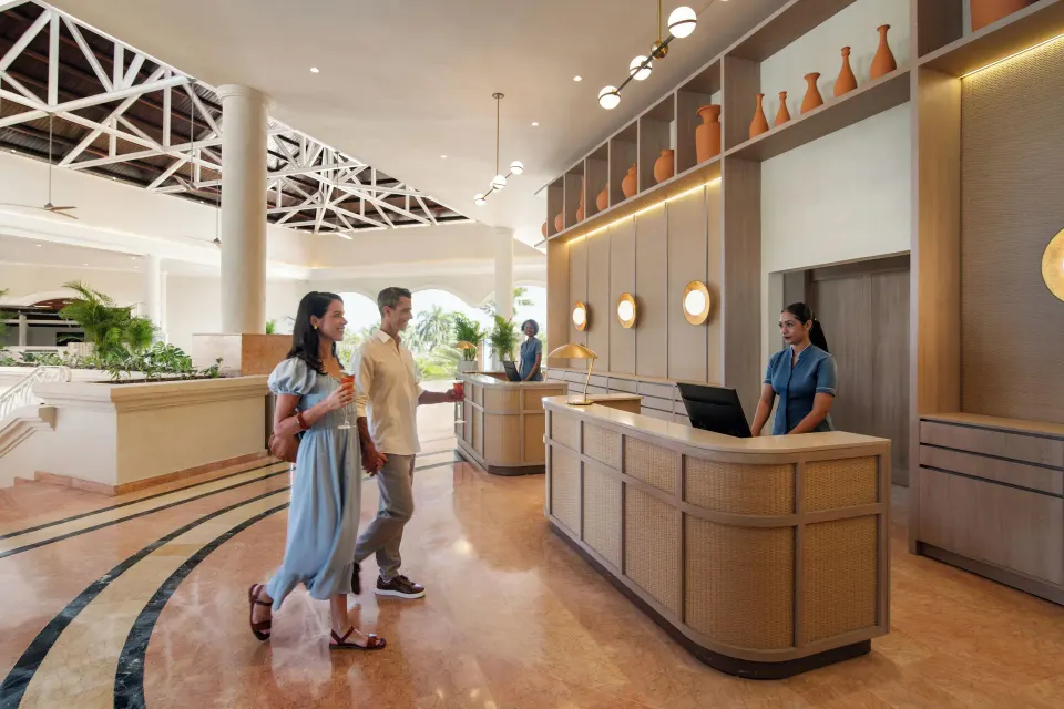 Guests walk past the front desk in the lobby at Wyndham Alltra Punta Cana.