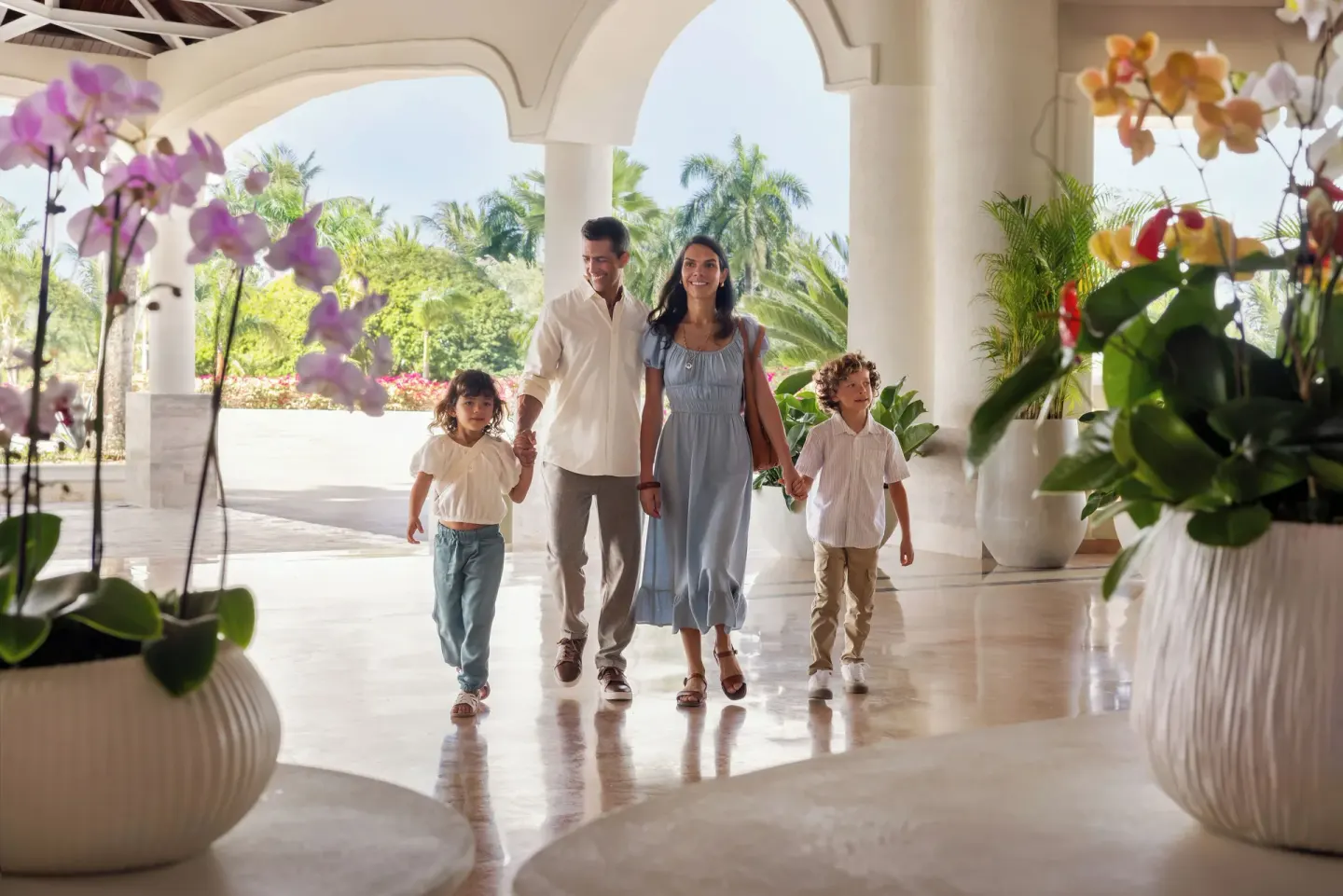Family walking through the open-air lobby at Wyndham Alltra Punta Cana.
