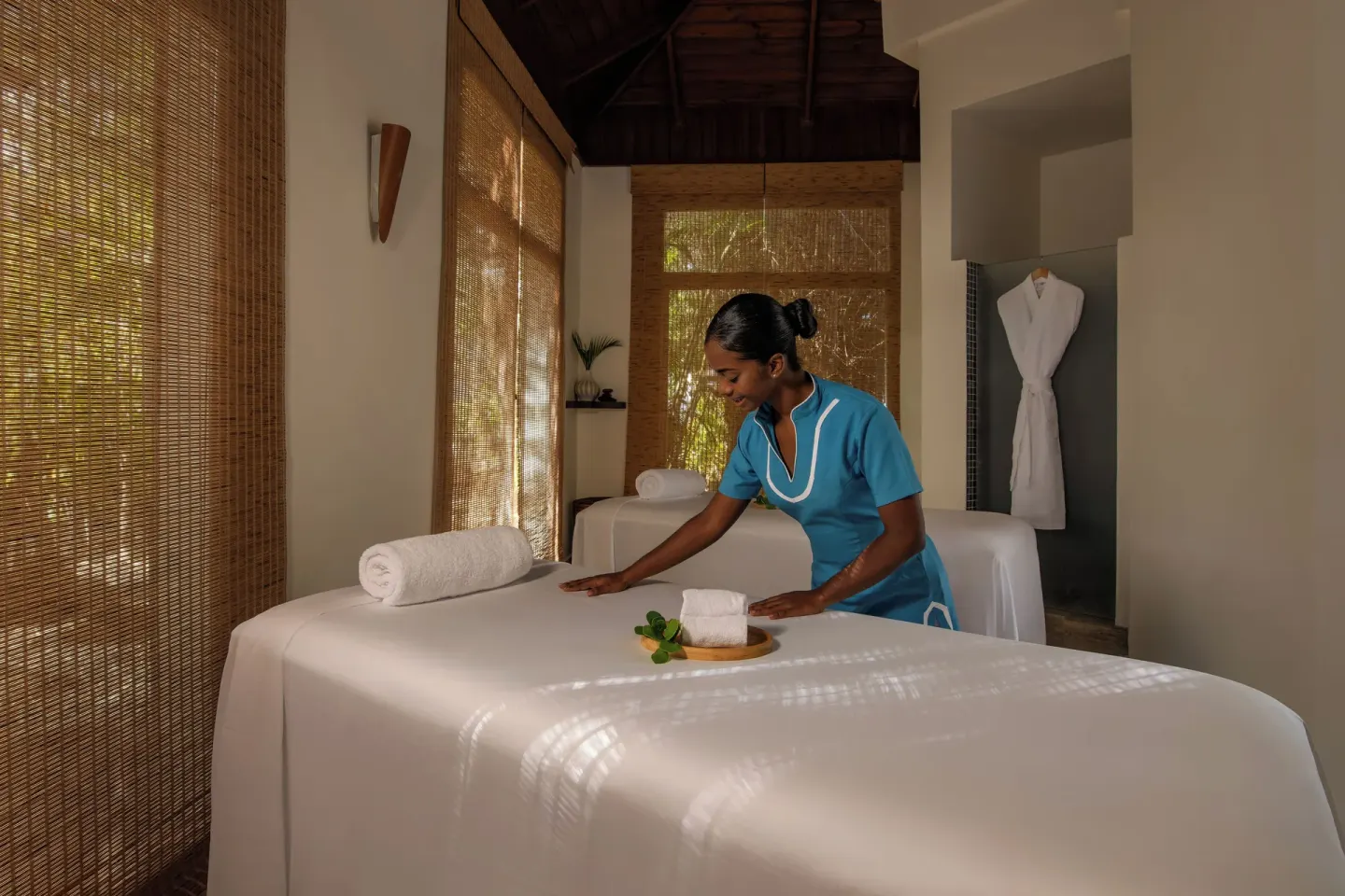 Spa attendant prepares a massage table at Wyndham Alltra Punta Cana.