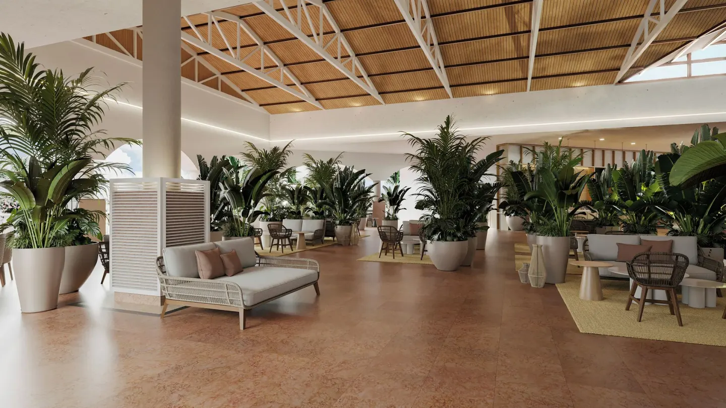 Plant-filled lobby seating area with sofas and tables at Wyndham Alltra Punta Cana.