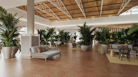 Plant-filled lobby seating area with sofas and tables at Wyndham Alltra Punta Cana.