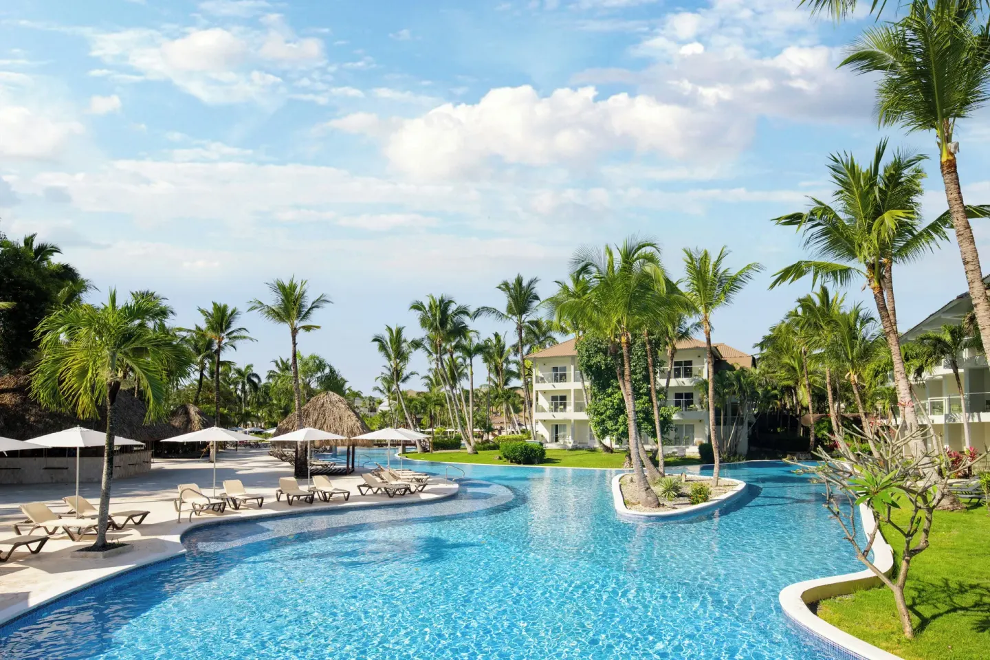 Quiet tropical pool with palms and loungers at Wyndham Alltra Punta Cana.
