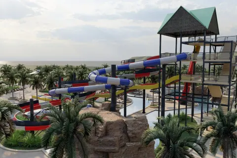 Elevated water slide tower near the palms and sea at Wyndham Alltra Punta Cana.