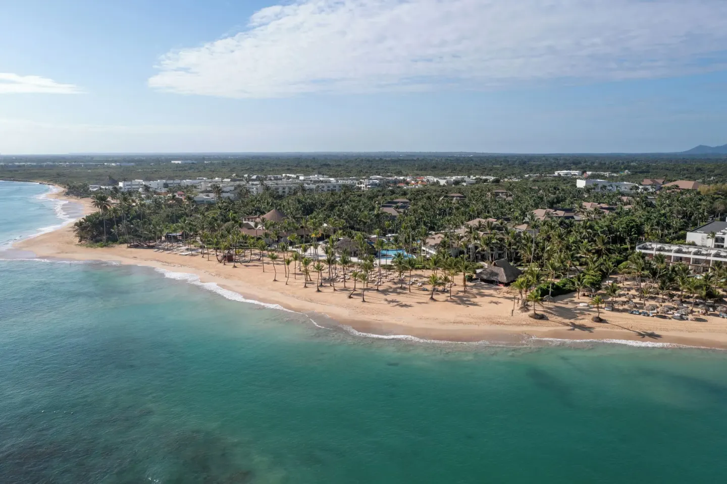 Wide aerial coastline view of Wyndham Alltra Punta Cana and its beach.