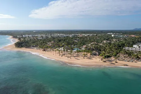 Wide aerial coastline view of Wyndham Alltra Punta Cana and its beach.