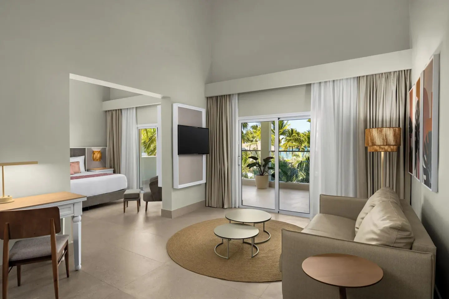 Junior suite living area with sofa bed and balcony view at Wyndham Alltra Punta Cana.