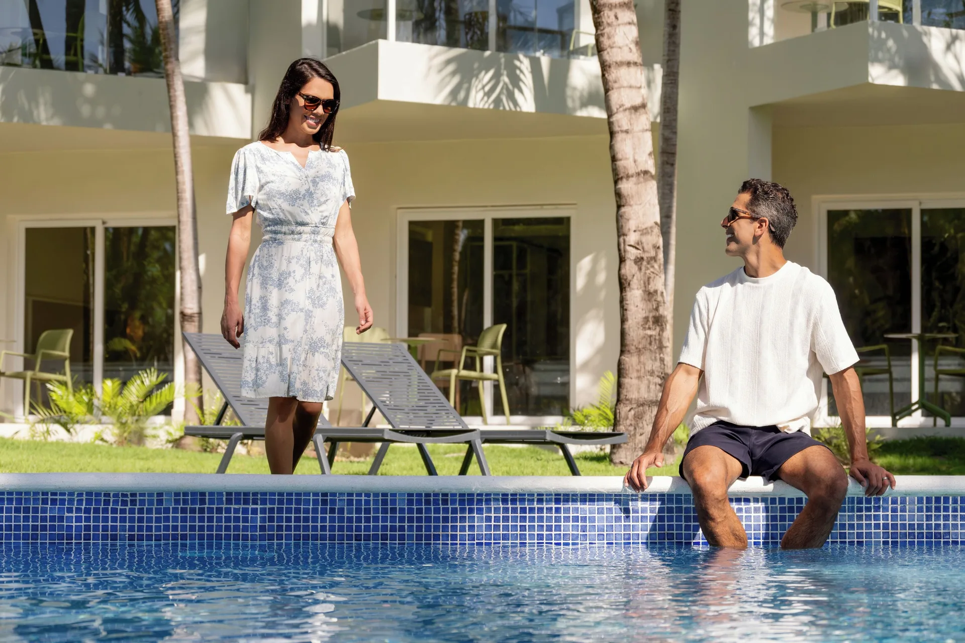 Guests by the pool outside pool walk-out rooms at Wyndham Alltra Punta Cana.