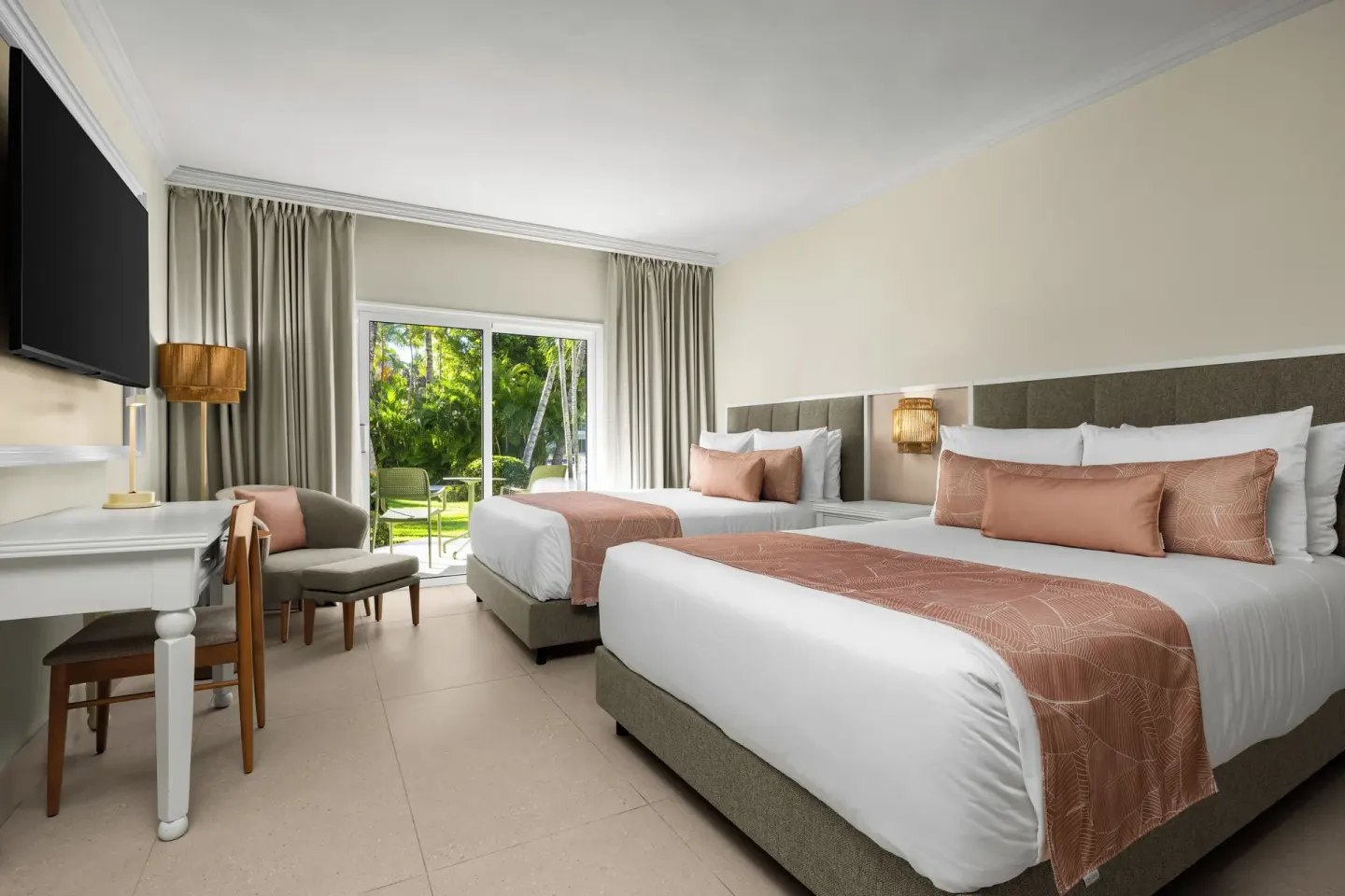Standard tropical view room with two queen beds and garden patio at Wyndham Alltra Punta Cana.