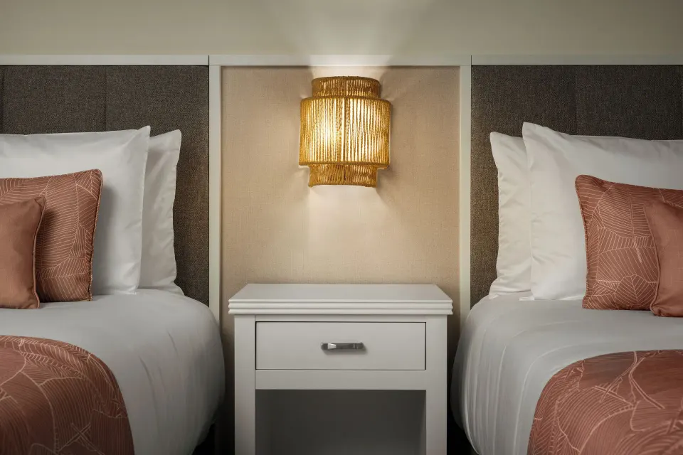 Standard tropical view room with two beds and central nightstand at Wyndham Alltra Punta Cana.