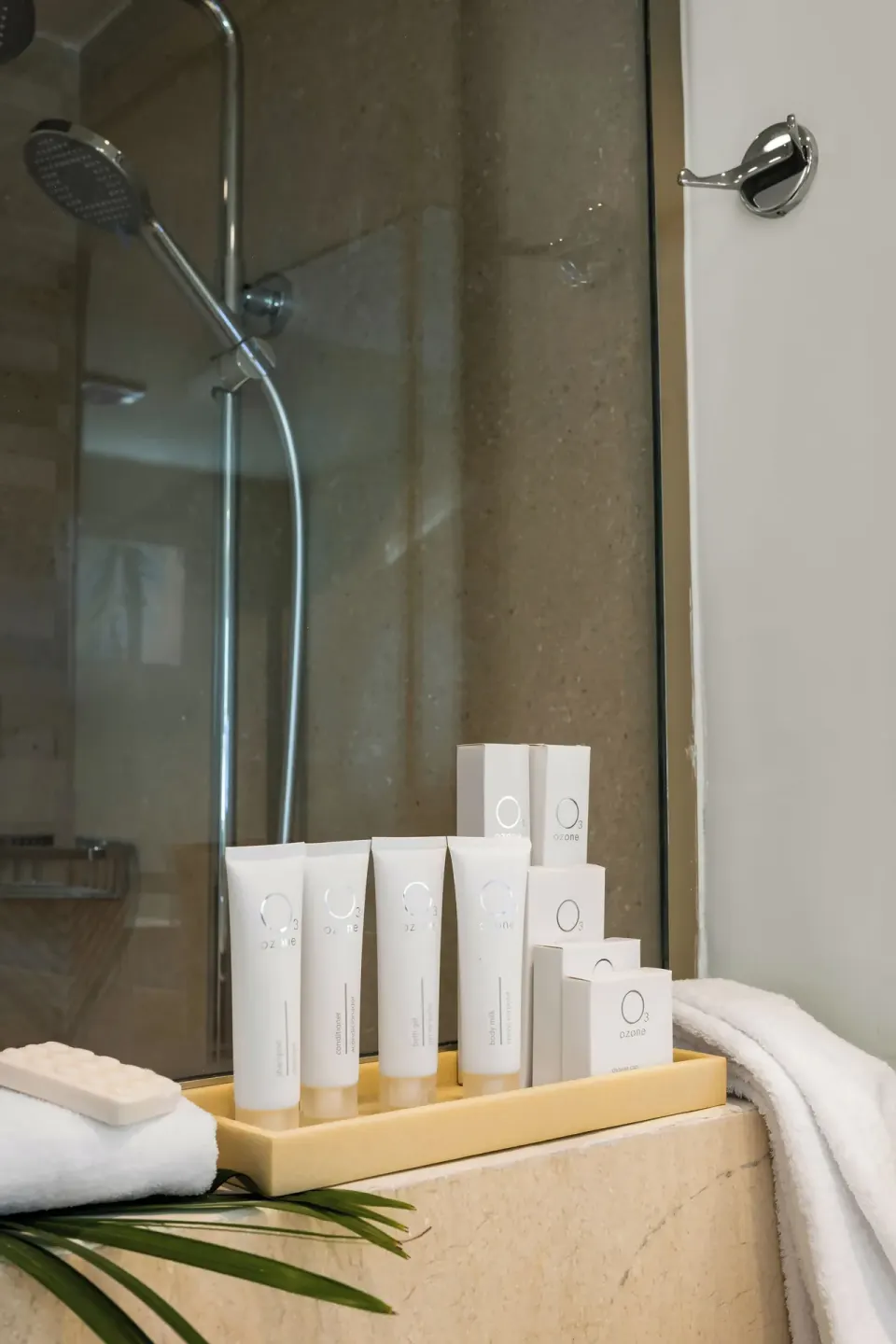 Bath amenities and towels beside the suite shower at Wyndham Alltra Punta Cana.