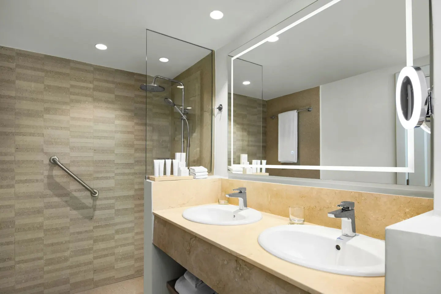 Suite bathroom with double sinks and glass shower at Wyndham Alltra Punta Cana.
